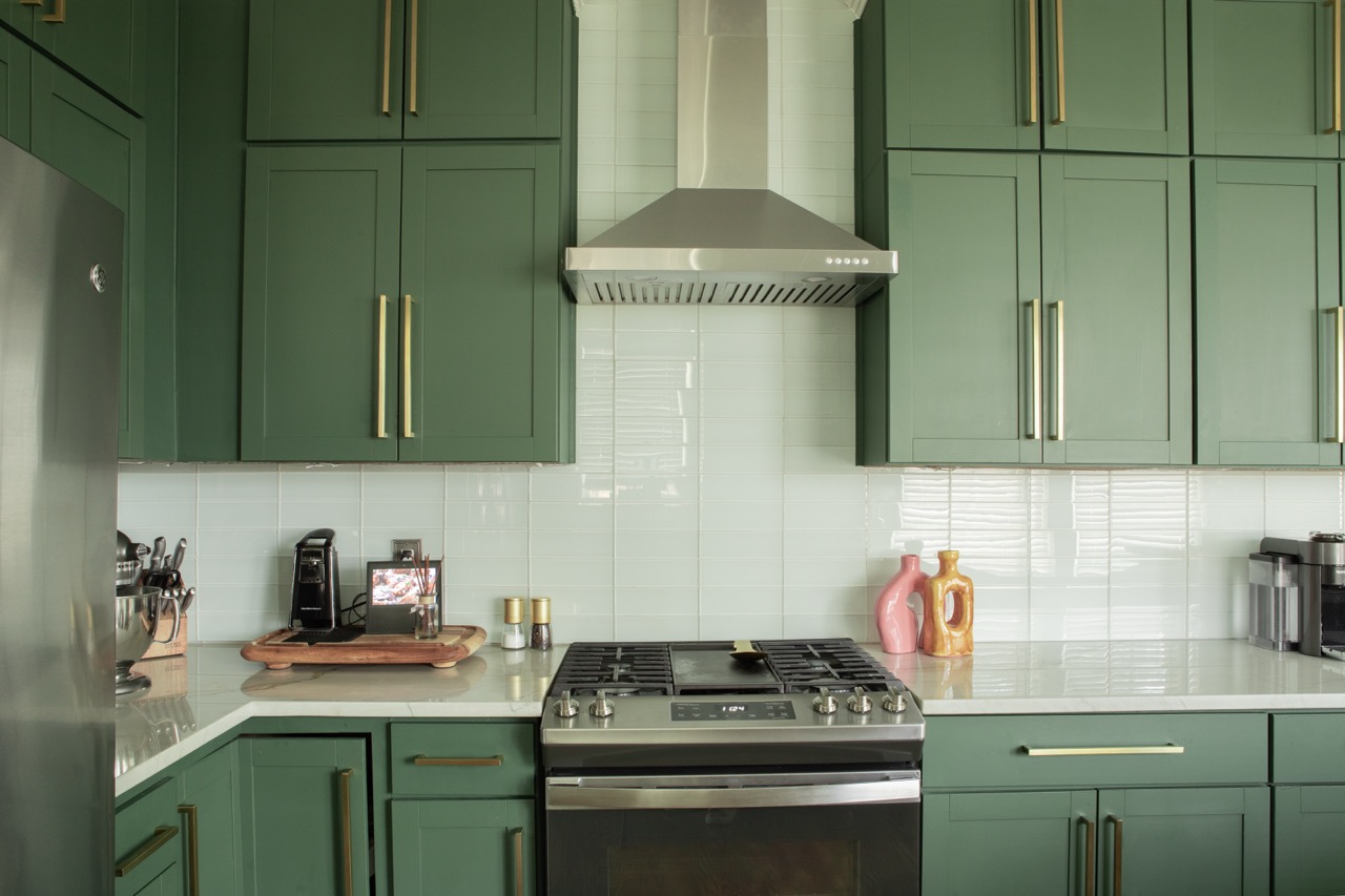 Updated kitchen with dark green cabinetry